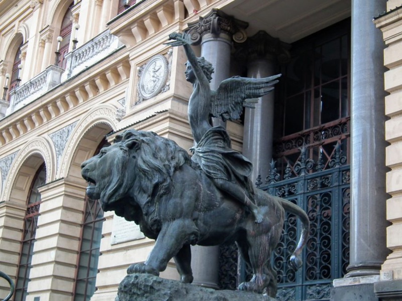 Bronze lion with boy riding