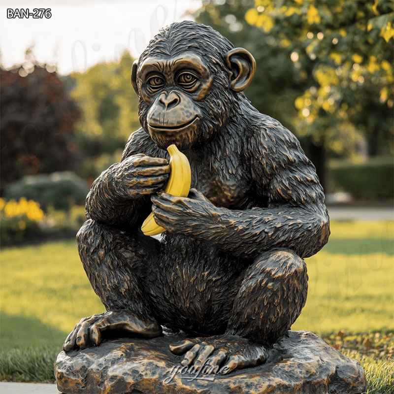 metal monkey sculpture eatting banana